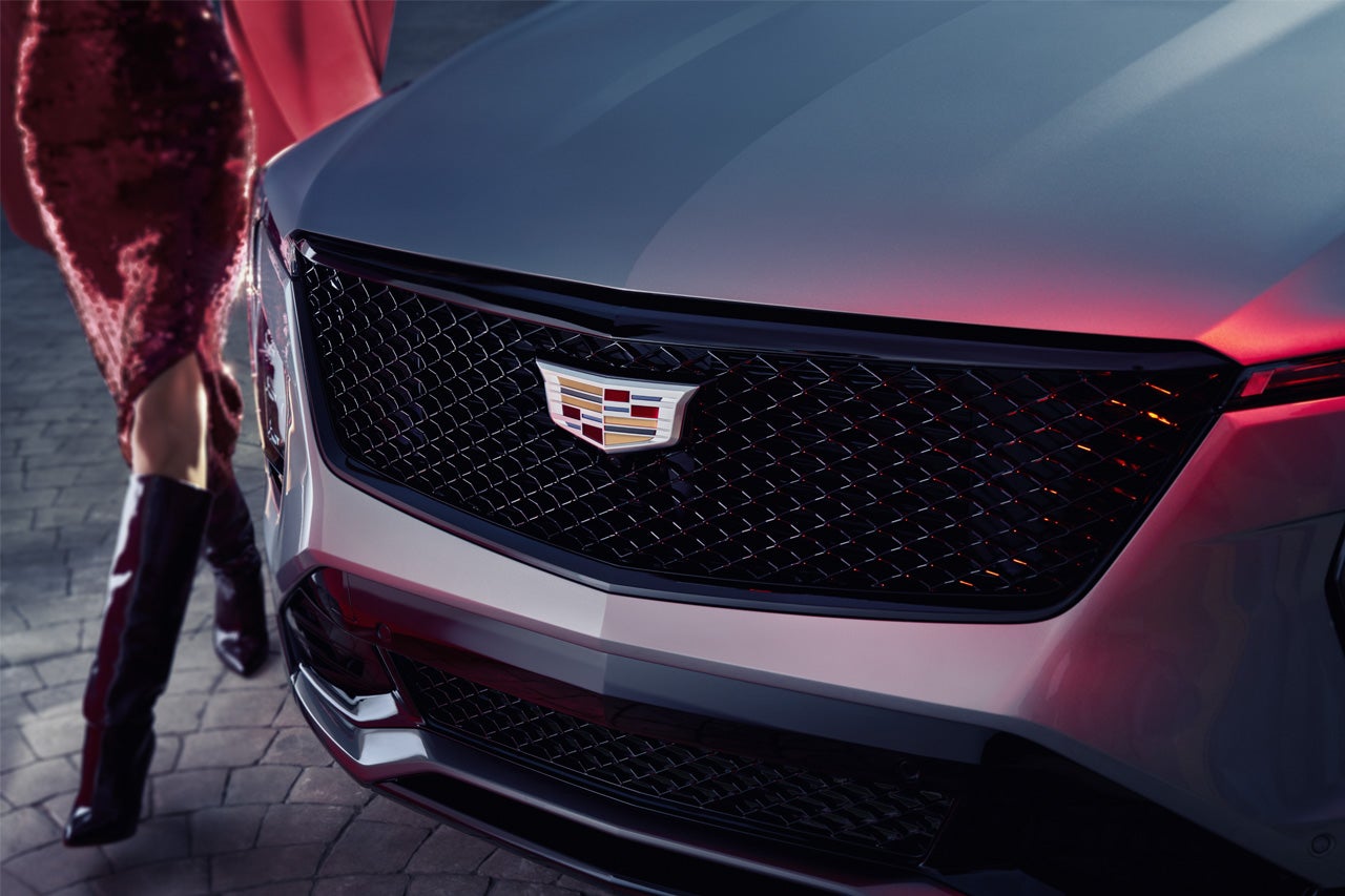 Close-up of a Woman Walking Past the 2025 Cadillac XT4 Grille