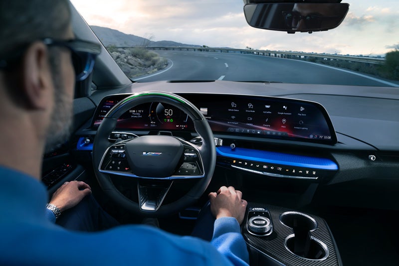 Front View of the 2026 OPTIQ-V Driving Through the Dusk Utilizing its Headlights | Epic Cadillac in Sacramento CA