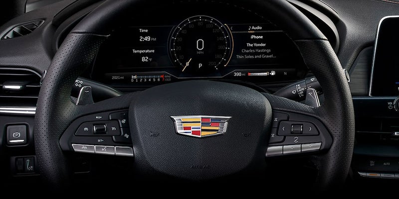 Close-up of Cadillac CT4 steering wheel and digital display.