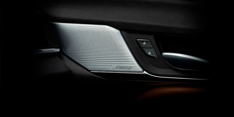Close-up of Cadillac CT4 door panel and Bose speaker.